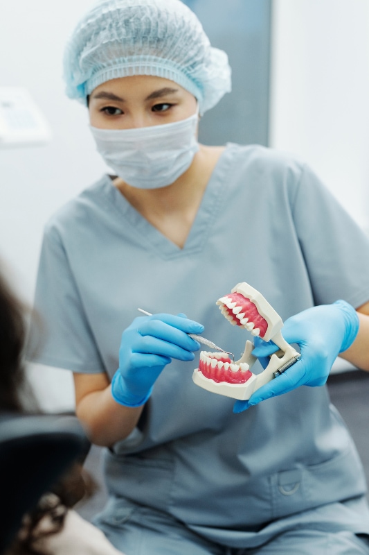 Dentist explaining to a patient | Canada Dental Care Plan